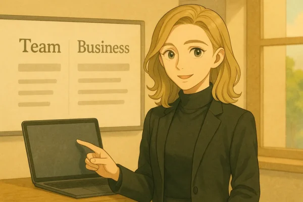 彩花がリモートで解説。背景モニターにTeam/Business比較ピクト。